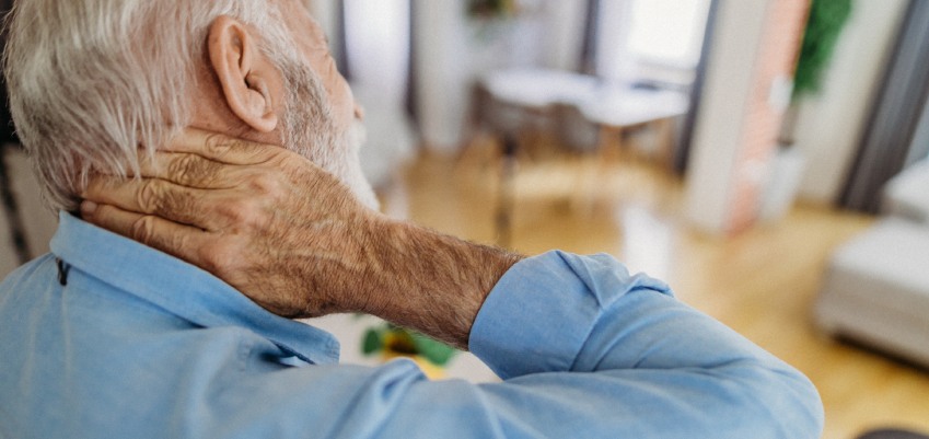 Older man having nerve pain on his neck